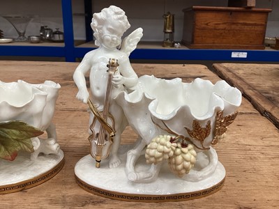 Lot 104 - Two similar late 19th century Moore Bros. porcelain sweetmeat baskets decorated with cherubs and gilt ornament, Greek Key pattern to footrims, stamped and impressed marks, 16.5cm high