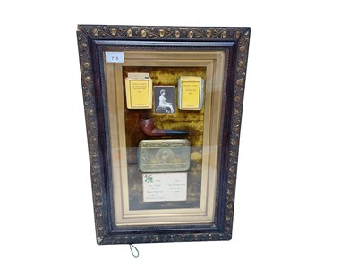 Lot 715 - First World War Princess Mary gift tin, mounted in glazed frame, with original photograph of Princess Mary, Christmas card, tobacco and cigarettes, 55 x 36cm.