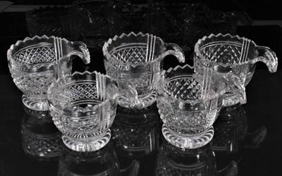 Lot 304 - Set of five George III Irish cut glass piggins with shell handles and pineapple-cut decoration