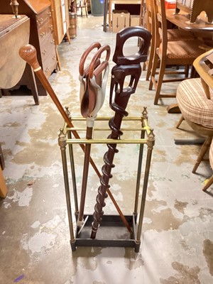 Lot 1261 - Brass and iron stick stand, together with two walking sticks and a shooting stick (4)