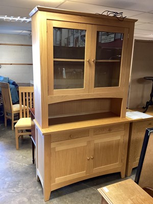 Lot 1263 - Mark Elliot Furniture light oak two height cabinet, with two glazed doors above, recess, two drawers and two panelled doors below, 121cm wide, 47cm deep, 211cm high