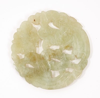 Lot 1010 - Chinese jade or green hardstone carved disc with bird and flower decoration