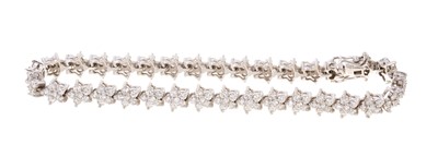 Lot 698 - Diamond bracelet consisting of thirty-two flower-head clusters, each cluster comprising six brilliant cut diamonds in 18ct white gold setting.  Estimated total diamond weight approximately 2.80 car...