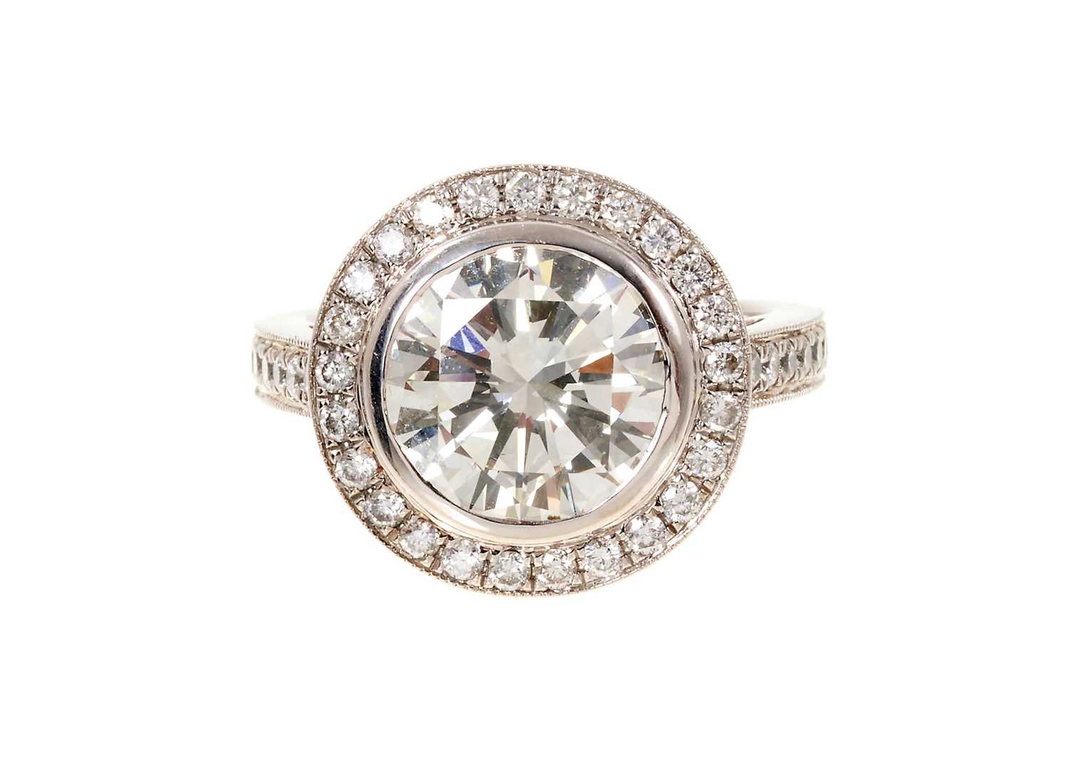 Lot 692 - Fine diamond single stone ring, the round brilliant cut diamond weighing 3.38 carats, in a rub-over setting, surrounded by a border of twenty-five brilliant cut diamonds with fourteen diamonds to t...