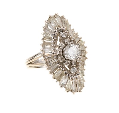 Lot 703 - Diamond cocktail ring with a marquise-shape cluster of brilliant and baguette cut diamonds in undulating tiered setting, centre stone approximately 0.55 carats