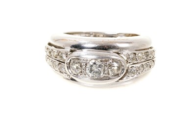 Lot 704 - White gold and diamond ring with a wide tapered band