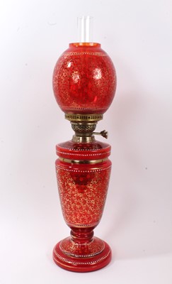 Lot 214 - Victorian cranberry glass oil lamp with matching shade