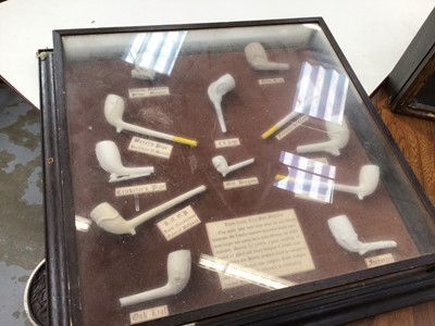 Lot 108 - Glazed case of clay pipes and another glazed display of pipes (2)