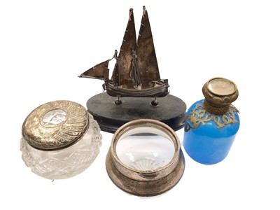 Lot 1089 - Continental silver model of a boat on wooden stand, two silver topped glass jars and a blue glass perfume bottle with gilt metal mounts