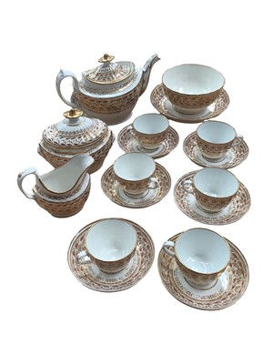 Lot 335 - Chamberlain Worcester tea set, circa 1800, decorated in gilt and enamel with a foliate pattern, comprising a teapot, cream jug, sucrier, bowl, six cups, six saucers and a side dish. Provenance: Rem...