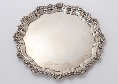 Lot 536 - Georgian-style silver card tray with cast shell and floral scroll border (Birmingham 1916) 21.5 cm diameter