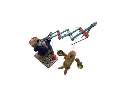 Lot 1894 - Vintage Japanese tinplate battery operated robot and a Japanese automaton clown with monkey playing the cymbals