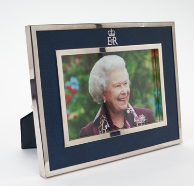 Lot 36 - H.M. Queen Elizabeth II, silver plated and leather photograph frame 2006 Royal Household Christmas present containing a charming photograph of Her Late Majesty with Crowned ERII cipher to frame and...