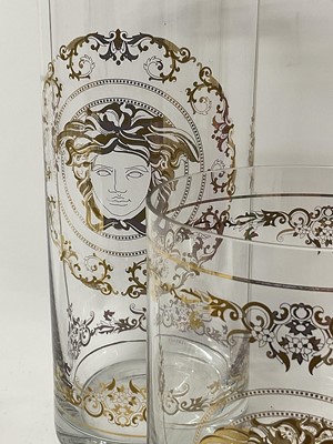 Lot 259 - Large Waterford Crystal 'Marquis' bowl, 24cm diameter, together with two Versace glass vases of cylindrical form with gilded decoration, 30cm and 16cm (3).