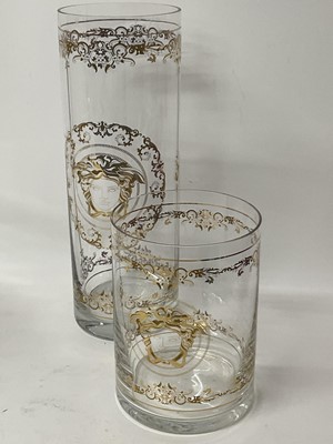 Lot 259 - Large Waterford Crystal 'Marquis' bowl, 24cm diameter, together with two Versace glass vases of cylindrical form with gilded decoration, 30cm and 16cm (3).