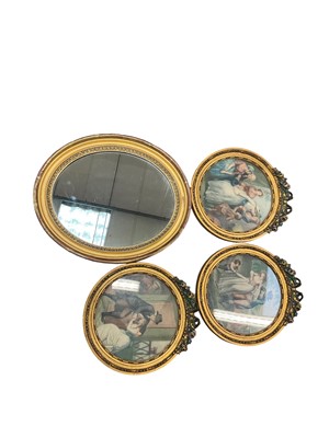 Lot 264 - After George Morland - Three antique coloured engravings in circular gilt frames with ribbon mounts, and an antique oval gilt framed wall mirror (4)