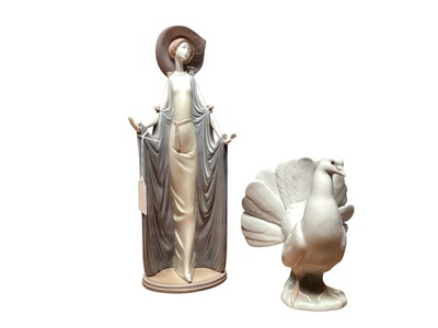 Lot 1153 - Lladro porcelain figure of a lady wearing a hat, together with a Lladro Dove (2)