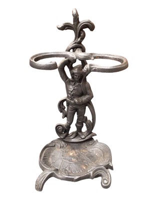 Lot 421 - Cast metal stick stand with figure and scroll decoration, 58cm high overall