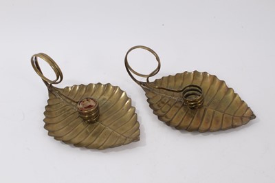 Lot 1055 - Pair of brass aesthetic movement chambersticks in the form of leaves by Joseph Sankey & Sons