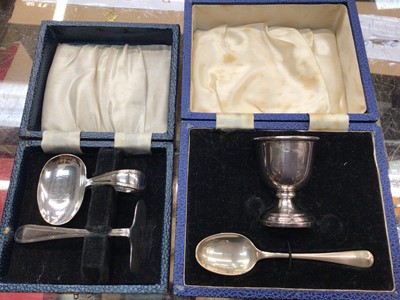 Lot 1108 - Silver egg cup and spoon set in fitted case, together with a plated spoon and pusher set