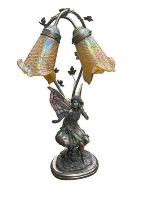 Lot 267 - Tiffany style table lamp with two iridescent glass shades and stained glass wings to the bronzed resin fairy.