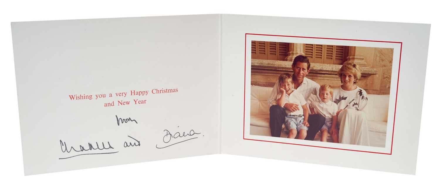 Lot 61 - T.R.H. The Prince and Princess of Wales, signed 1986 Christmas card with twin gilt ciphers to cover, colour photograph of the relaxed Royal couple with their young sons on holiday in Spain, signed...