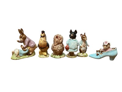 Lot 1128 - Eleven Beswick Beatrix Potter figures and a Beswick stand