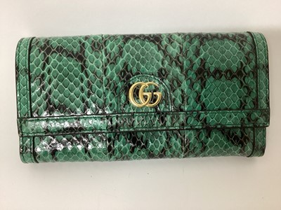 Lot 2072 - Gucci green python skin clutch purse with soft bag.