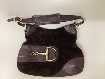 Lot 2074 - Gucci brown leather and suede handbag with large gold tone horse bit.