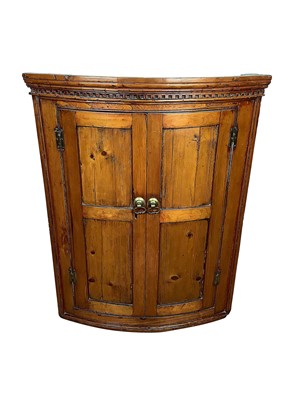 Lot 1587 - George III pine bowfront corner cupboard