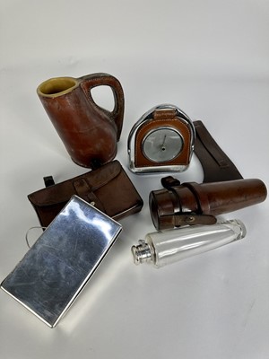 Lot 1244 - Leather cased glass saddle flask with silver plated top, James Dixon & Sons sandwich box in leather case for saddle mounting, desk barometer suspended from a stirrup and a leather covered jack (4)