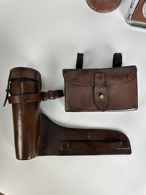 Lot 1244 - Leather cased glass saddle flask with silver plated top, James Dixon & Sons sandwich box in leather case for saddle mounting, desk barometer suspended from a stirrup and a leather covered jack (4)