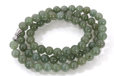 Lot 806 - Jadeite jade bead necklace with a string of 7.1-7.5mm spherical beads accompanied by a GIA certificate stating no indications of impregnation/treatment. 54cm length.