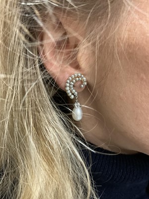 Lot 826 - Pair of Art Deco style natural salt water pearl and diamond earrings, each graduated pearl scroll suspending a 4.31 and 4.54ct natural saltwater pearl with rose cut diamond mounts, 34mm.