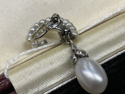 Lot 826 - Pair of Art Deco style natural salt water pearl and diamond earrings, each graduated pearl scroll suspending a 4.31 and 4.54ct natural saltwater pearl with rose cut diamond mounts, 34mm.