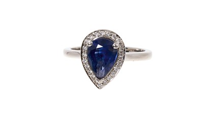 Lot 741 - Sapphire and diamond cluster ring with a pear cut blue sapphire measuring approximately 8mm x 6mm surrounded by a border of brilliant cut diamonds on platinum shank, ring size I.