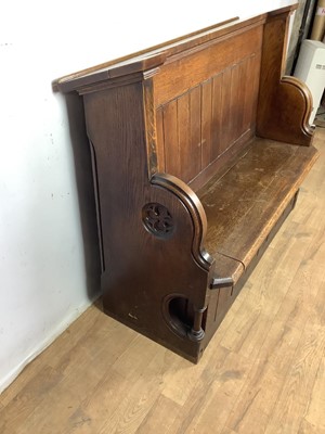 Lot 1596 - Victorian oak pew, with hinged seat and high ledge back, tracery ornament to the solid ends, 132cm long