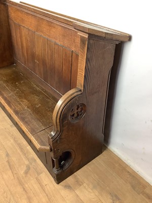 Lot 1596 - Victorian oak pew, with hinged seat and high ledge back, tracery ornament to the solid ends, 132cm long