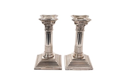 Lot 564 - Pair George V silver Corinthian column candlesticks, on stepped square bases, with beaded borders and separate sconces, (Sheffield 1935), maker William Bush & Son Ltd, 17cm in overall height.