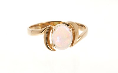 Lot 677 - Opal single stone ring with an oval opal cabochon measuring approximately 8.5 x 7mm in 14ct gold crossover setting, ring size T.