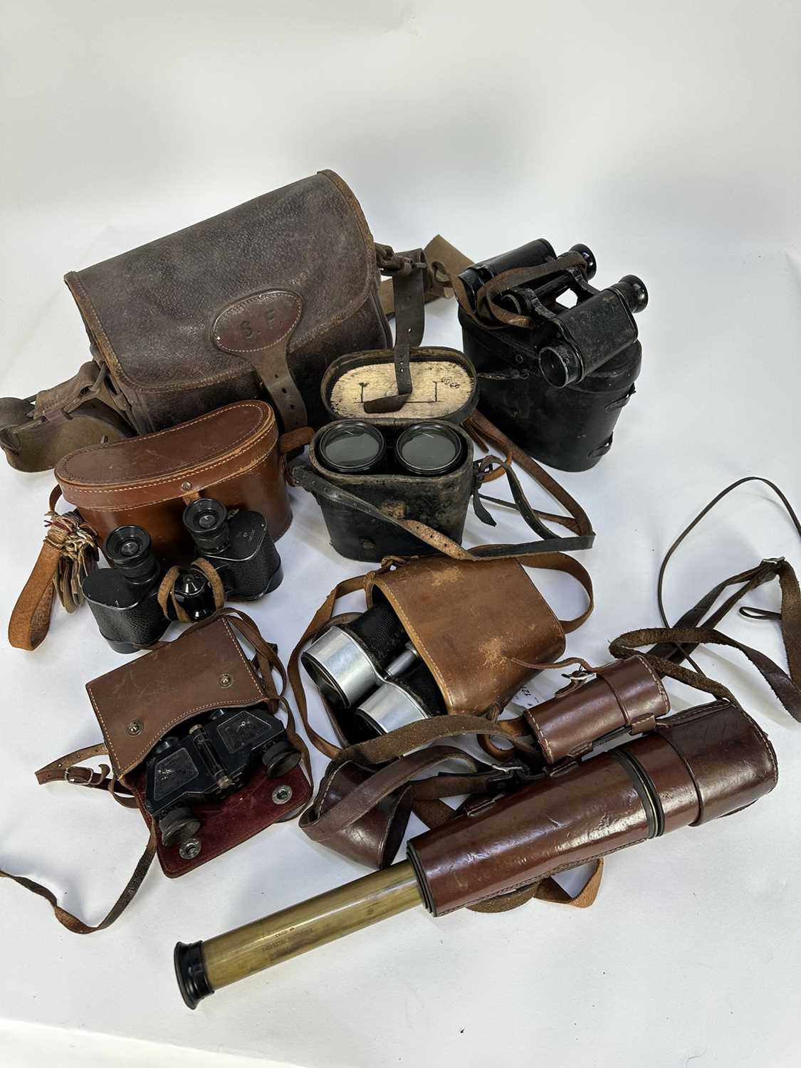 Lot 1214 - Five pairs of vintage leather cased binoculars, leather cartridge bag and a Dollond of London Signalling Telescope No. 10283