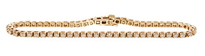 Lot 836 - Diamond tennis bracelet with a line of sixty one brilliant cut diamonds in 14ct yellow gold setting, estimated total diamond weight approximately 1.83cts. Length 18cm.