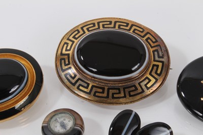 Lot 688 - A group of Victorian agate jewellery to include a carved agate cameo stick pin, a pair of 9ct gold and banded agate cufflinks, two gold black enamel and banded agate brooches, another black agate b...