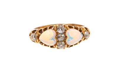 Lot 674 - Victorian opal and diamond ring with two heart-shape opal cabochons and five old cut diamonds in gold claw setting on tapered gold shank. Ring size N.