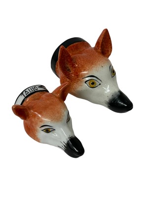 Lot 1250 - Two Staffordshire pottery fox mask stirrup cups worth painted and sponged decoration, 13cm and 10cm