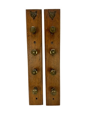 Lot 1252 - Pair of antique whip racks, a label verso 'The hooks on this rack are old pad pedestals, as formally used on carriage harness', mounted on oak panels with retailers plaque for The Colchester Saddle...