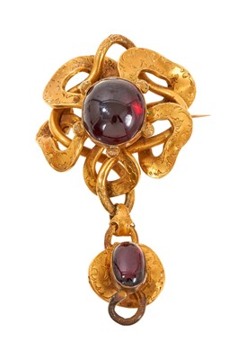 Lot 651 - Victorian gold and cabochon garnet pendant brooch with an engraved gold bow with central garnet, suspending a further garnet pendant drop with glazed locket compartment to the reverse, 70mm.