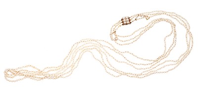 Lot 653 - Antique pearl necklace with a long triple string of seed pearls measuring approximately 2-3.3mm (not tested for natural origin), on a gold a seed pearl clasp, 84cm length.