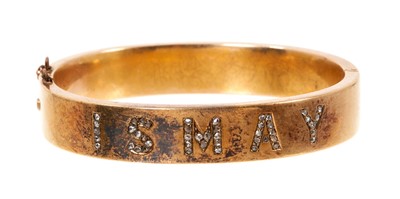 Lot 658 - Victorian gold and diamond hinged bangle, the wide plain gold band with rose cut diamonds spelling 'ISMAY'.