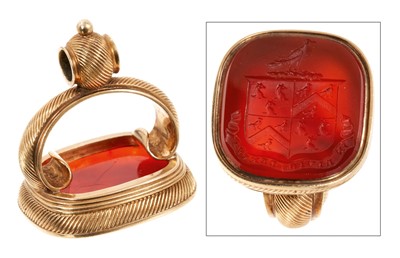 Lot 663 - Large good quality 19th century yellow metal seal, the carnelian with intaglio engraved family crest and motto, 35mm high.